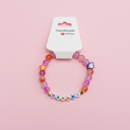 Personalised beaded bracelet on pastel pink background